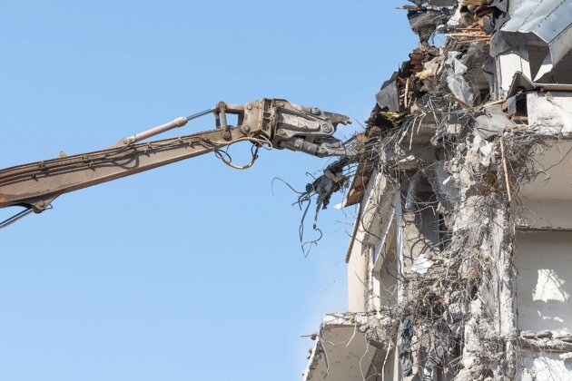 Heavy equipment hydraulic shears arrow dismantle the building, demolition destruction. Heavy equipment hydraulic shears arrow dismantle the building, demolition destruction.